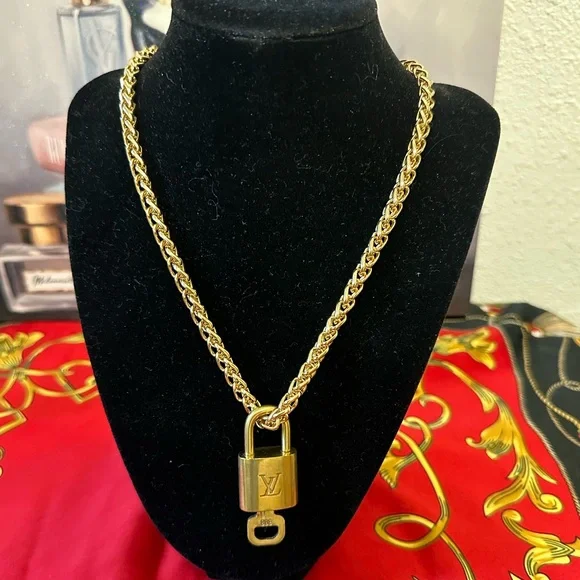 Authentic Louis Vuitton lock and key #308
with unbranded chain and earrings. - Picture 1 of 5